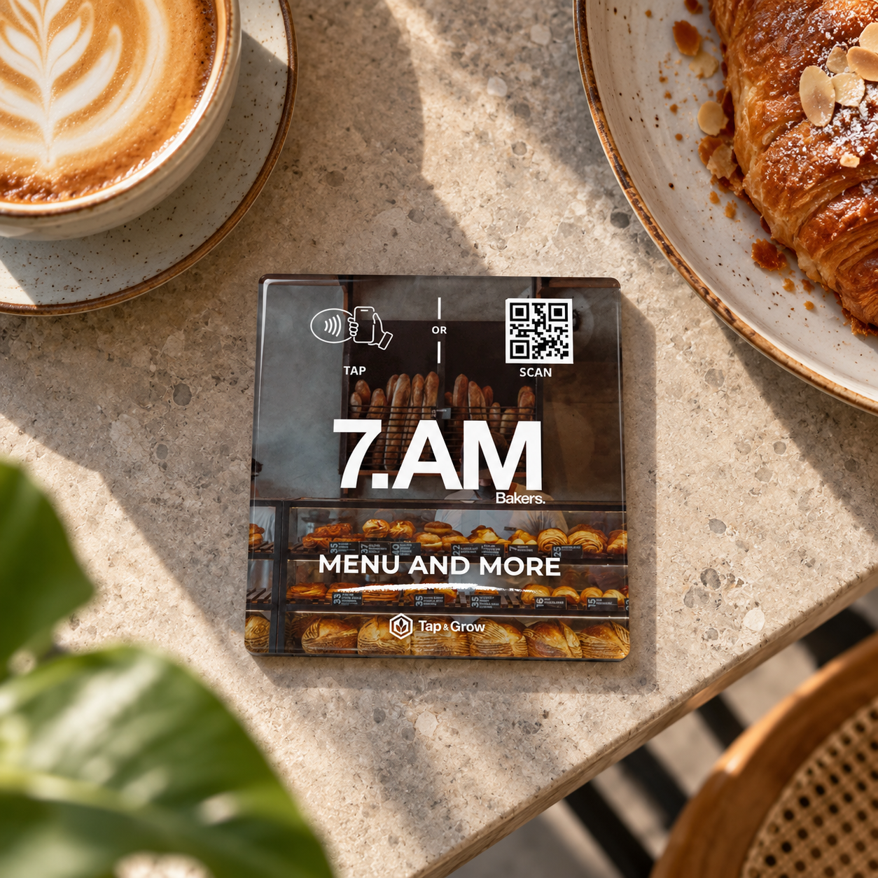 Proposed 7AM NFC piece beside coffee and a croissant